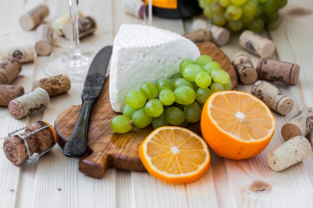 Homemade cheese with grapes and a glass of champagne