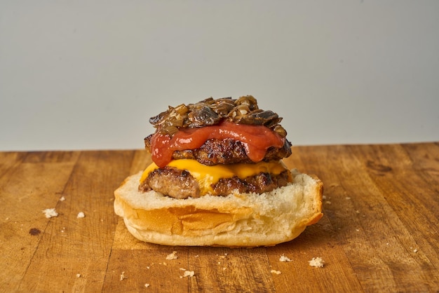 Homemade cheeseburger with organic bread ,two hamburger patties and two slices of  cheddar cheese