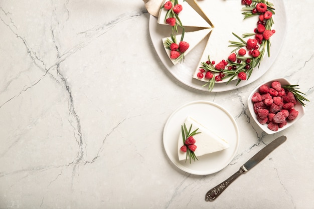 Homemade cheesecake with raspberries on a plate. View from above. Place for text.