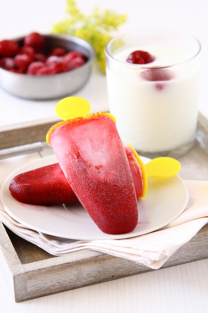 Homemade cherry ice cream popsicle with yogurt