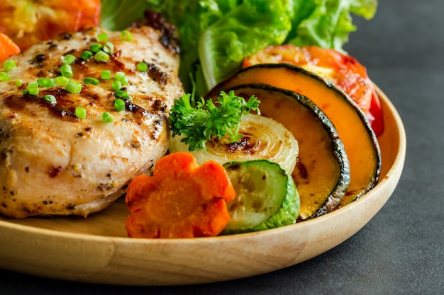 Homemade chicken breast barbecue served with grilled vegetables. 