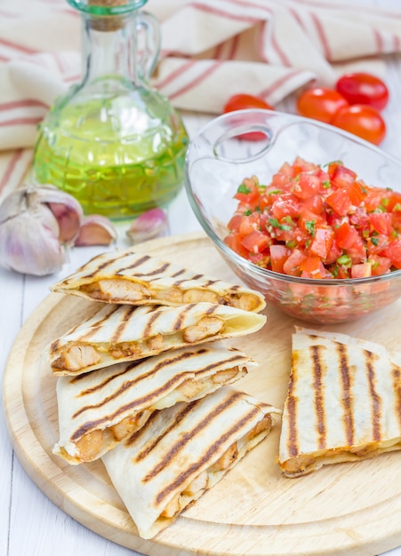 Homemade chicken and cheese quesadilla with salsa