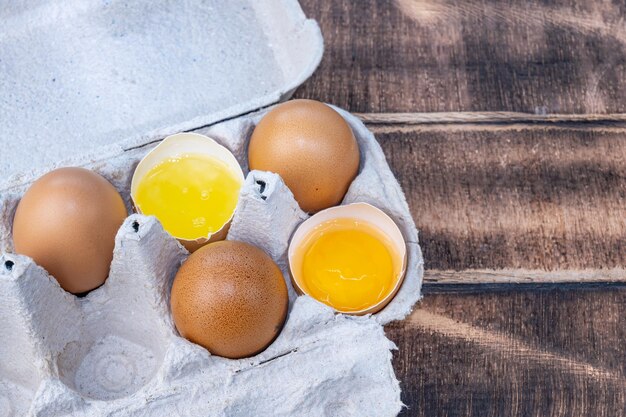 Homemade chicken eggs broken eggs egg yolk white eggs in a paper tray