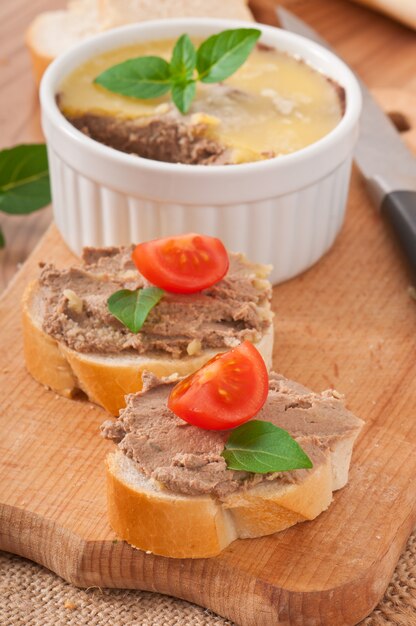 Homemade chicken liver pate, basil and slices of white bread