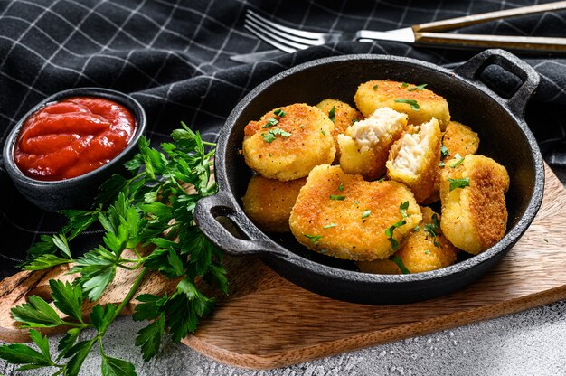 Homemade Chicken nuggets and ketchup sauce in a pan.