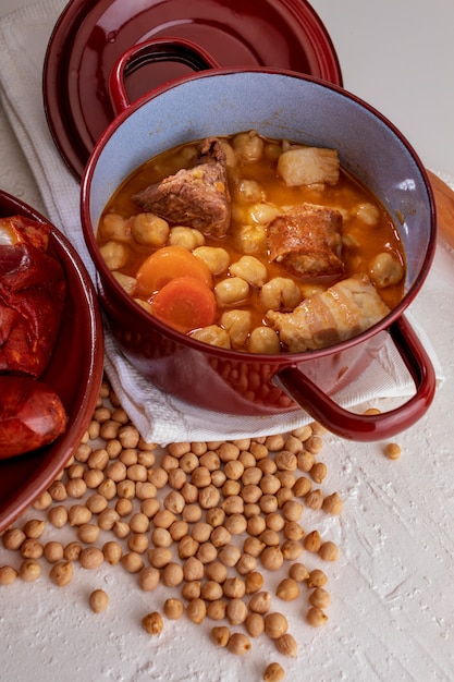 Homemade chickpea stew Madrid stew of chickpeas, meat and vegetables (chorizo, blood sausage, ham, garlic, onion, carrot, veal, chicken). Typical Spanish dish