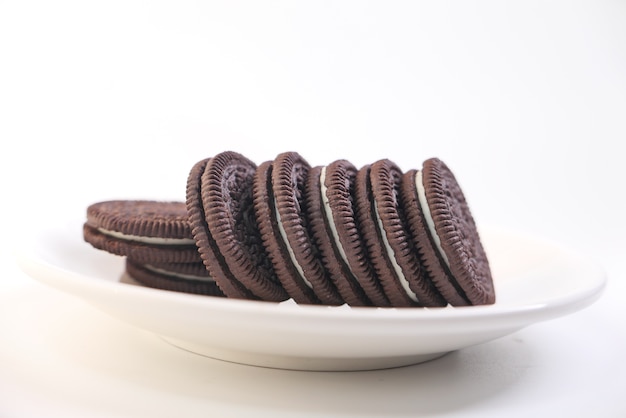 Homemade chocolate biscuits on plate isolated on white .