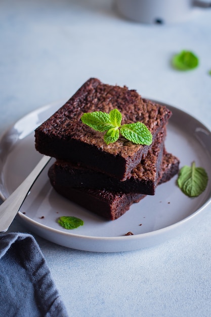 Homemade chocolate brownies on blue stone background