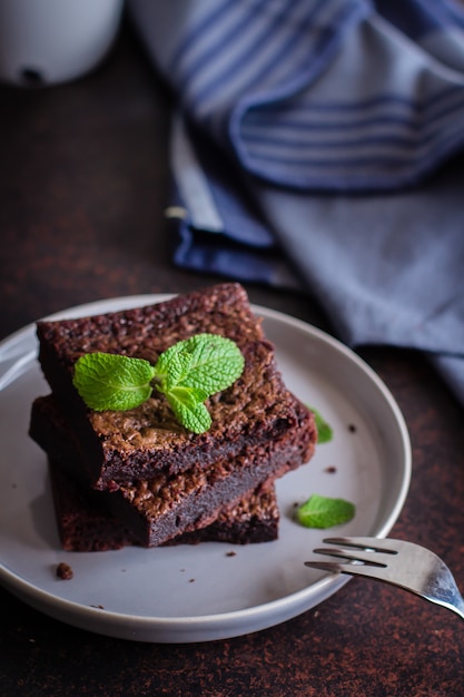 Homemade chocolate brownies on blue stone background