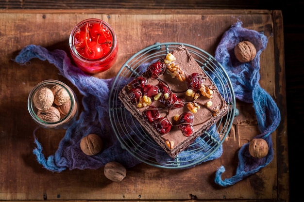 Homemade chocolate cake with cherries and walnuts