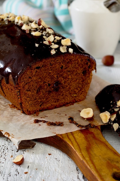 Homemade chocolate cake with chocolate icing and nuts