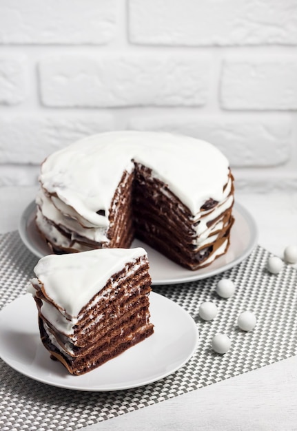 Homemade chocolate cake with cream. Slice of cake on a plate