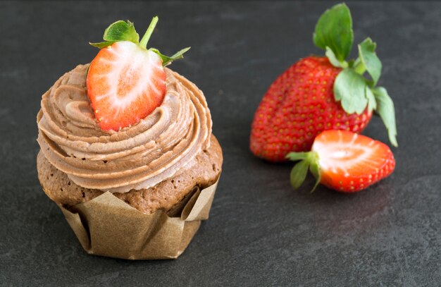 Homemade chocolate cake with cream and strawberry.