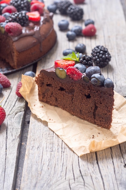 Homemade chocolate cake with summer berries and mint