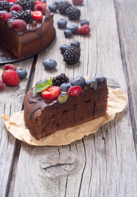 Homemade chocolate cake with summer berries and mint