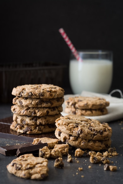 Homemade chocolate cookies and milk on slate