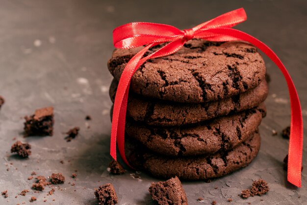 Homemade chocolate cookies with cracks on black background.