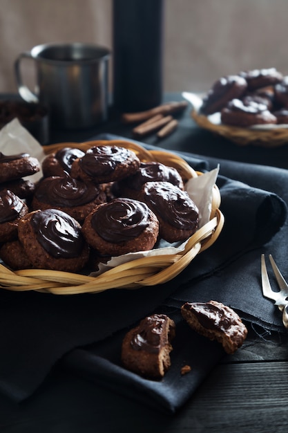 Homemade chocolate cookies with tea on dark table