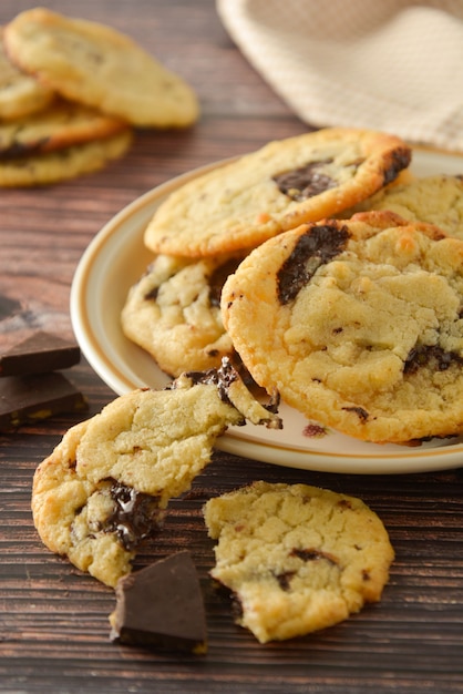 Homemade chocolate cookies on wooden table.