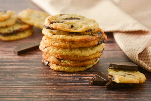 Homemade chocolate cookies on wooden table.