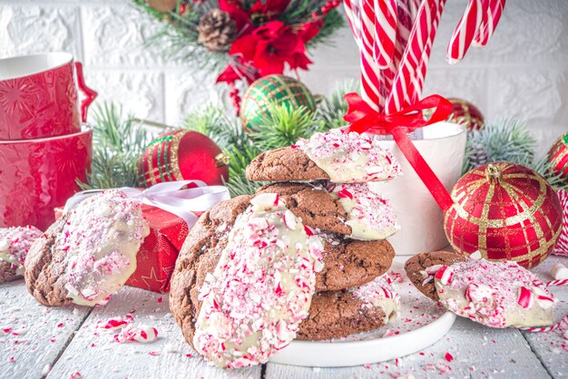 Homemade chocolate cracked brownie cookies dipped in white chocolate and candy cane bits