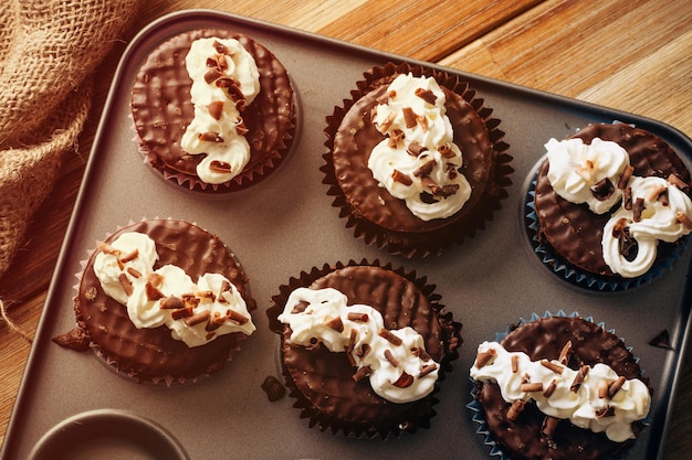 Homemade chocolate cupcakes in cupcake mold on the table in the kitchen