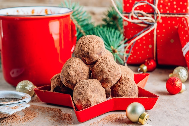 Homemade chocolate truffles candy ball on a christmas background. Selective focus