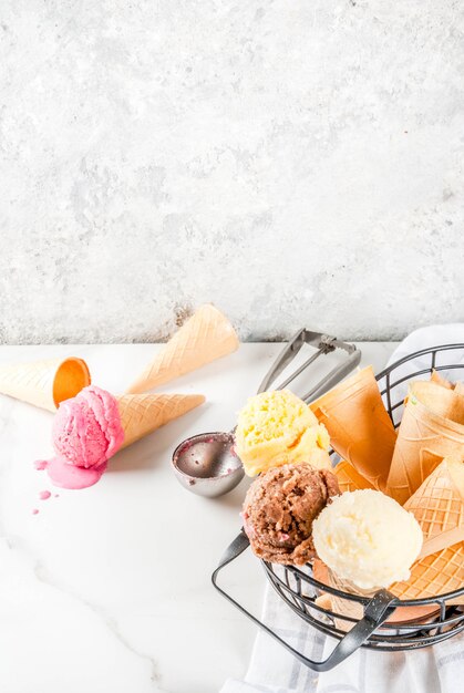 Homemade chocolate, vanilla, berry ice cream in ice cream cones