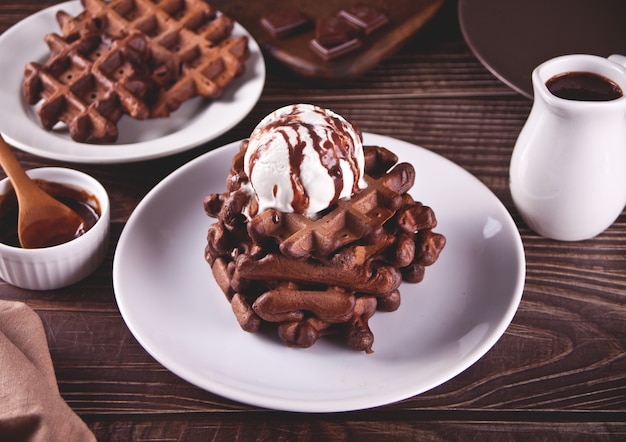Homemade chocolate waffles with ice cream decorated chocolate syrup