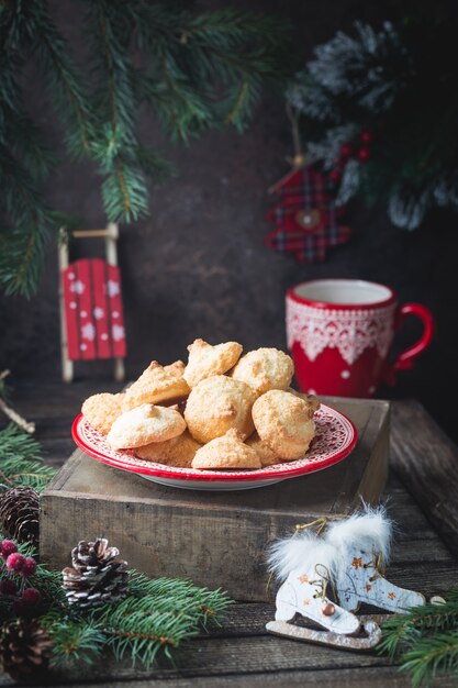 Homemade christmas cookies in a red plate with festive decoration