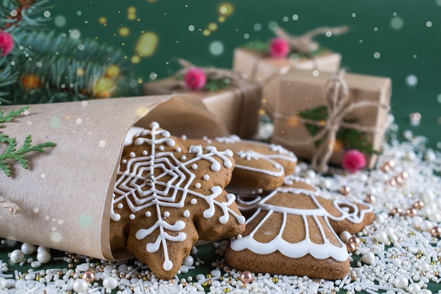 Homemade christmas cookies with decor on  green  surface