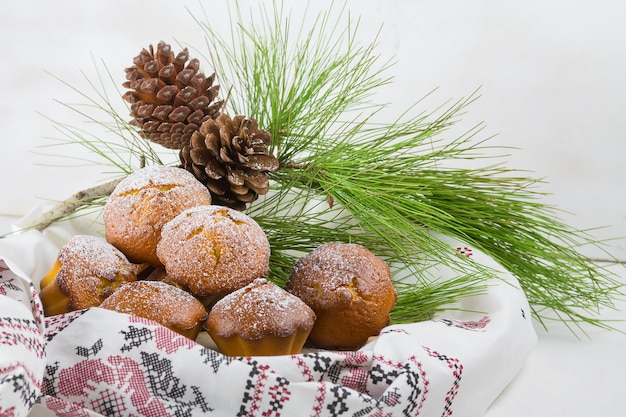 Homemade christmas cupcake, christmas muffins and new year decoration and pine branches and cones