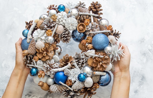 Homemade Christmas wreath on a concrete table