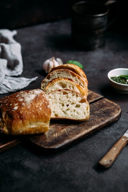 Homemade ciabatta bread sliced bread slices on a wooden board
bread