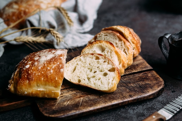 Homemade ciabatta bread sliced bread slices on a wooden board\
bread