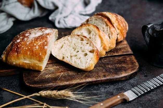 Homemade ciabatta bread sliced bread slices on a wooden board\
bread