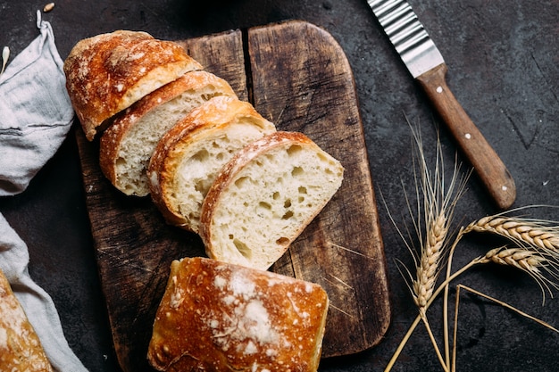 Homemade ciabatta bread sliced bread slices on a wooden board\
bread