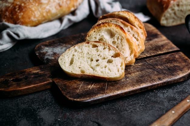 Homemade ciabatta bread sliced bread slices on a wooden board
bread