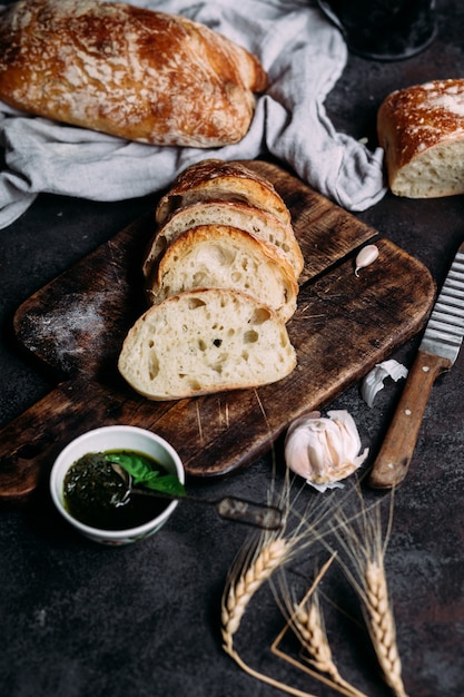 Homemade ciabatta bread sliced bread slices on a wooden board\
bread