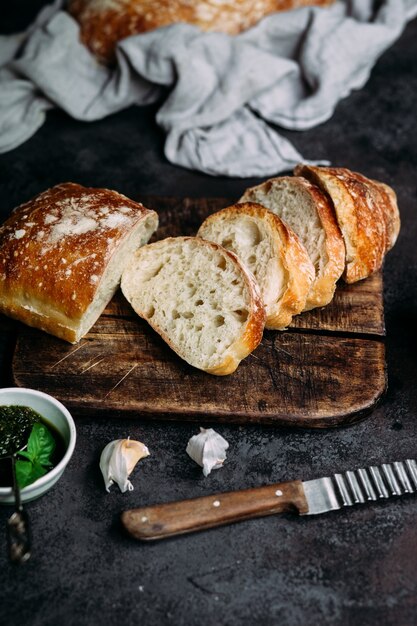 Homemade ciabatta bread sliced bread slices on a wooden board\
bread