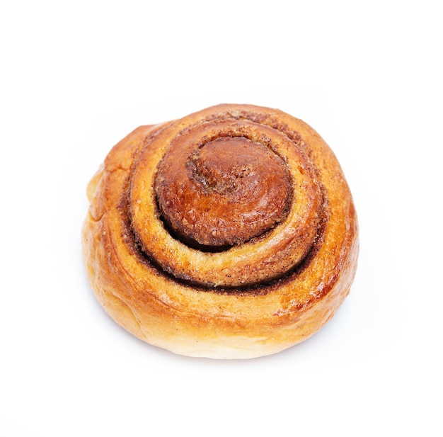 Homemade cinnamon bun isolated on a white background, close-up