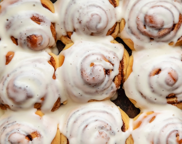 Homemade cinnamon buns in glaze, copy space,