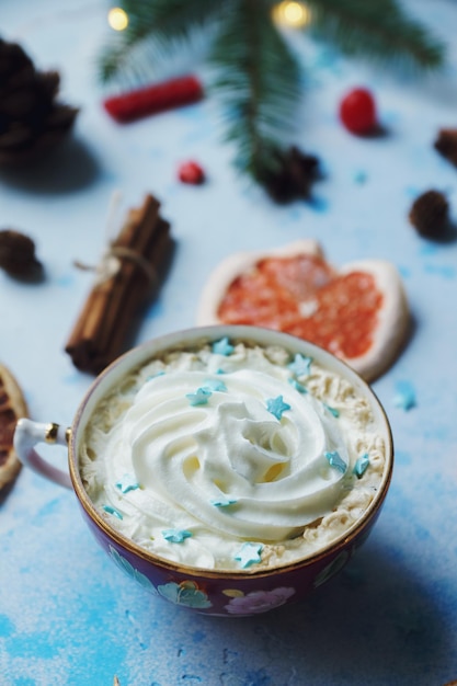 Foto cacao fatto in casa o cioccolata calda con crema di arance essiccate abete cannella caramelle su sfondo blu cemento natale o capodanno bevanda accogliente decorazione domestica messa a fuoco selettiva