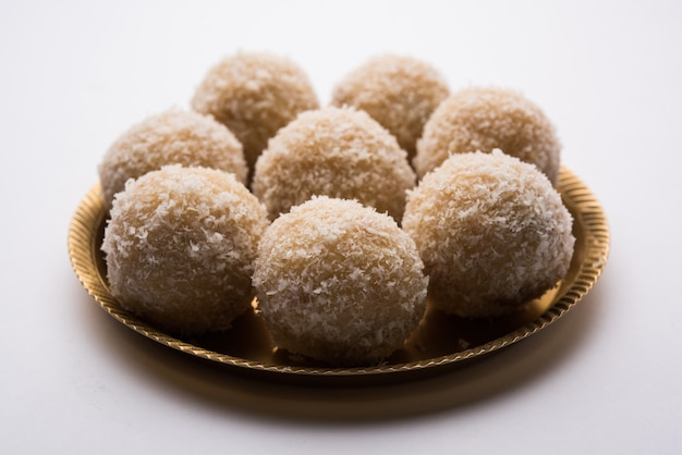 Homemade Coconut Sweet Laddoo OR Nariyal Laddu made with Condensed Milk and Sugar, Popular Festival food. Served over moody background, selective focus