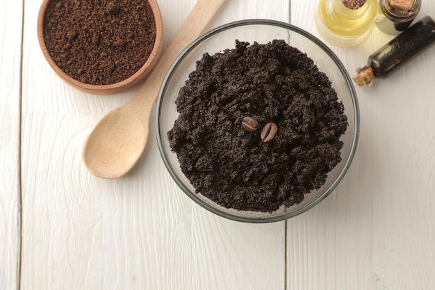 Homemade coffee scrub in a jar for the face and body and various ingredients for making scrub on a light background spa cosmetics care cosmetics view from above