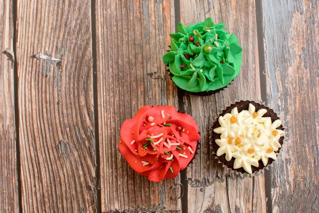 Homemade colorful cupcakes on wooden table