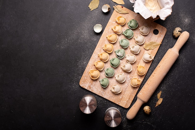 Homemade colorful meat dumplings on a wooden board