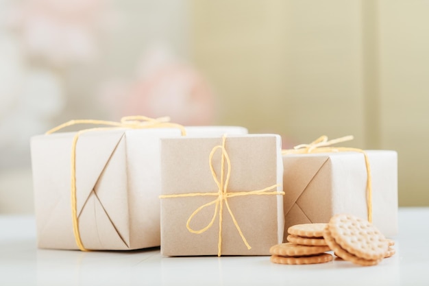 Homemade cookies Bakery food delivery Rustic paper gift boxes tied with yellow cord Blur background Copy space