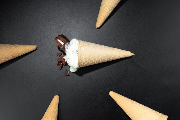 Homemade cookies and cream cone ice cream dark background photo\
with flash flashy food ice cream