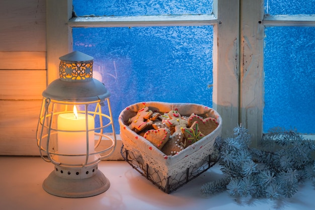 Homemade cookies on white table and blue window for Christmas